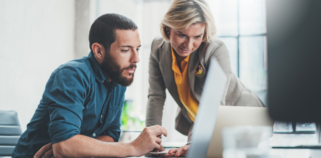 Man and woman working on a computer